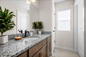 Bathroom featuring vanity and baseboards