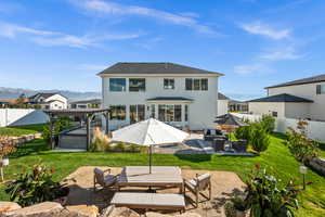 Back of house with an outdoor living space, a fenced backyard, a patio area, a mountain view, and a pergola