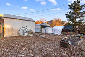 View of yard featuring an outbuilding, a garden, and a mountain view