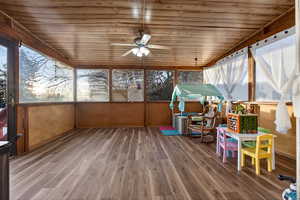 Sunroom featuring ceiling fan and healthy amount of natural light