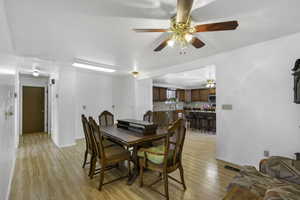 Dining room with light wood-style flooring and baseboards