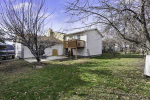 View of property exterior featuring a yard and a patio area