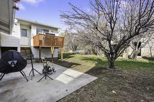 View of green lawn with a patio area