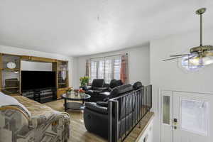 Living area featuring light wood finished floors and ceiling fan