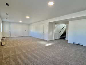 Basement featuring carpet, stairs, and recessed lighting