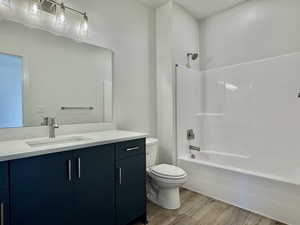 Full bathroom featuring light wood-style flooring, vanity, and tub / shower combination