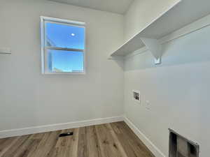 Washroom featuring wood finished floors and hookup for a washing machine