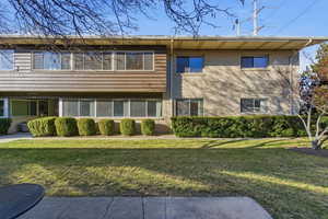 View of front of house with brick siding and a front yard