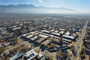 Aerial view of property and surrounding area with a mountain backdrop