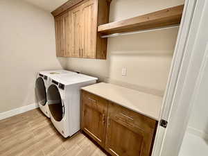 Front loader washer and dryer with plenty of storage space and a counter for folding laundry