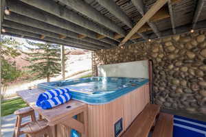 View of patio featuring a hot tub
