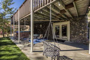 View of patio with a hot tub and french doors