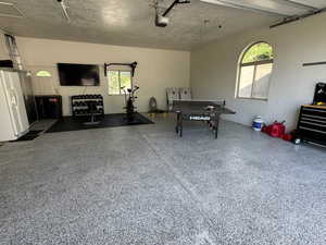 Garage with white refrigerator with ice dispenser