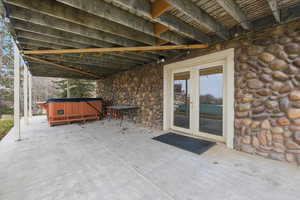 View of patio / terrace with a hot tub and french doors