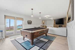 Playroom featuring billiards, a wainscoted wall, and light wood-type flooring