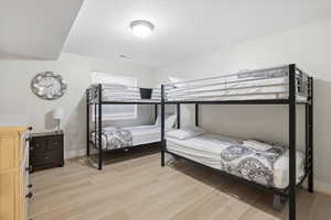 Bedroom featuring light wood finished floors and baseboards