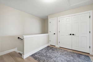 Foyer with light wood-type flooring and baseboards