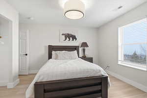 Bedroom featuring light wood finished floors and baseboards