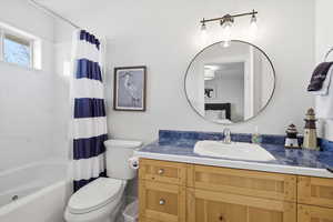 Full bath with vanity and shower / bath combo with shower curtain