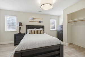 Bedroom featuring baseboards and light wood-type flooring