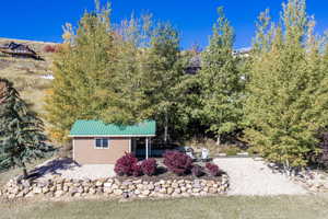 Back of house with a metal roof and a patio