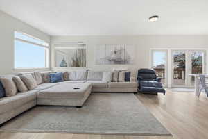 Living area with light wood-style flooring and plenty of natural light