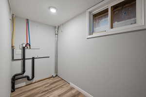 Laundry area featuring light wood finished floors and washer hookup