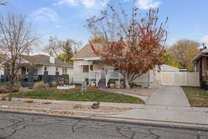 Bungalow-style house with a gate, a porch, roof with shingles, and a garage