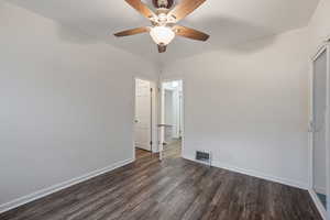 Unfurnished room with dark wood-style flooring and ceiling fan