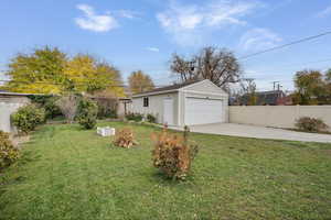 Fenced yard with an outbuilding and a garage