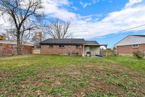 Back of house with a patio, a fenced backyard, and brick siding