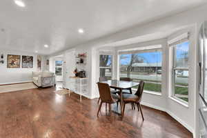 Dining area with dark wood-style flooring and recessed lighting