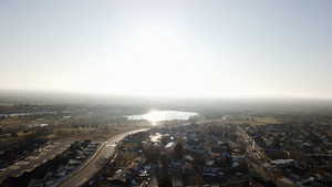 View of property location with a large body of water and nearby suburban area