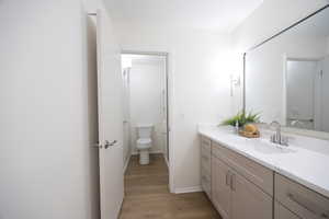 Bathroom featuring vanity and light wood-style floors