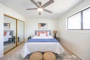 Bedroom with carpet floors, ceiling fan, and a closet