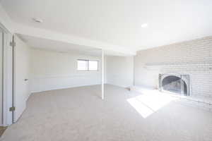Basement featuring a fireplace and carpet flooring