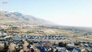 Aerial view of property's location with nearby suburban area and a mountain backdrop