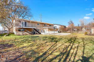 Back of house with stairway and a patio area