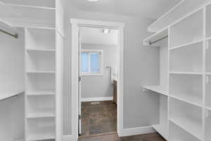 Main bedroom walk through closet with custom shelving on each side