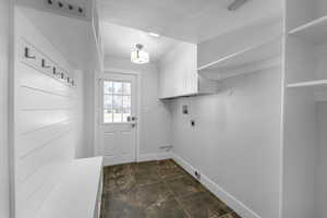 Washroom featuring cabinet space, hookup for an electric dryer, and washer hookup, and door to backyard
