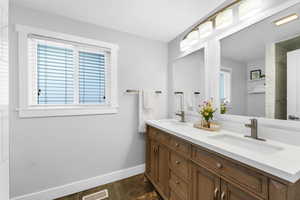 Main bathroom with double sinks and quartz countertop