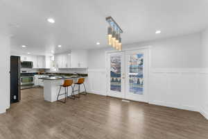 Dining Room featuring french door openging onto a patio and wainscoting