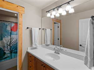 Bathroom featuring vanity and shower / tub combo