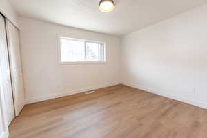 Unfurnished bedroom featuring a closet and light wood-type flooring