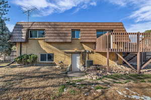 Back of property featuring brick siding