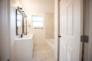 Full bath featuring vanity, a textured ceiling, and shower / washtub combination