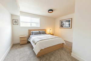 Bedroom with light carpet and a textured ceiling