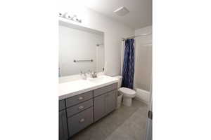 Bathroom #2 featuring vanity, shower / tub combo, and light tile patterned flooring