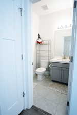 Half bath featuring vanity and light tile patterned floors