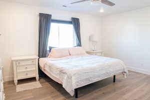 Primary Bedroom with light wood laminate  flooring and ceiling fan